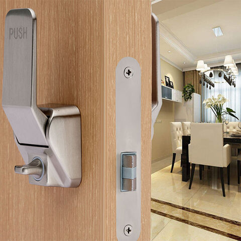 Push-style door lock installed on a wooden door