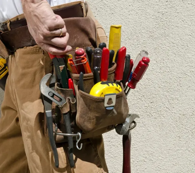 Handyman tool belt with wrench, screwdrivers, and hammer